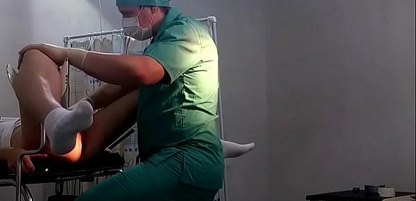  A girl in white socks on a gynecological chair